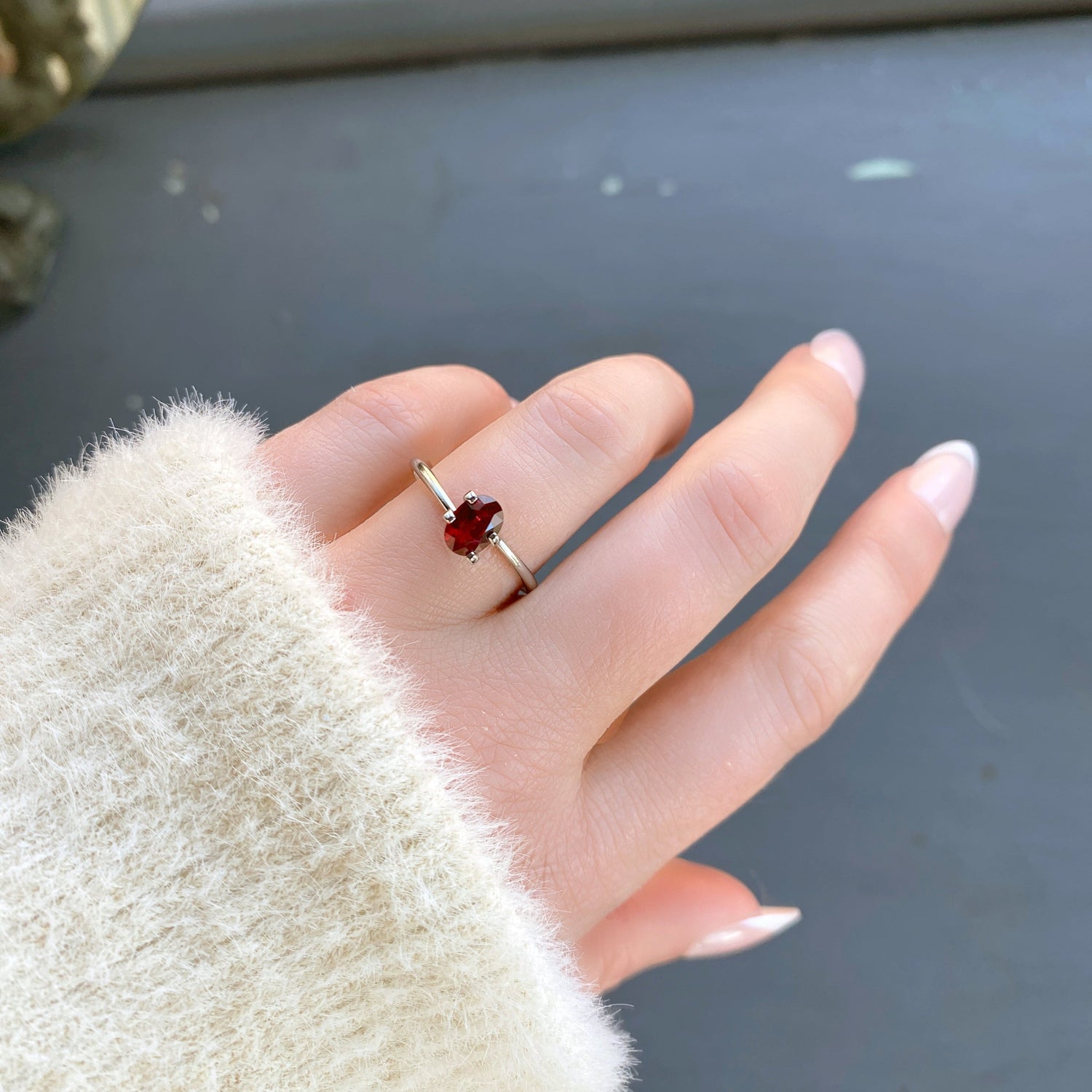 a 0.89 ct oval ruby in a temporary ring mounting in diffused winter sunlight