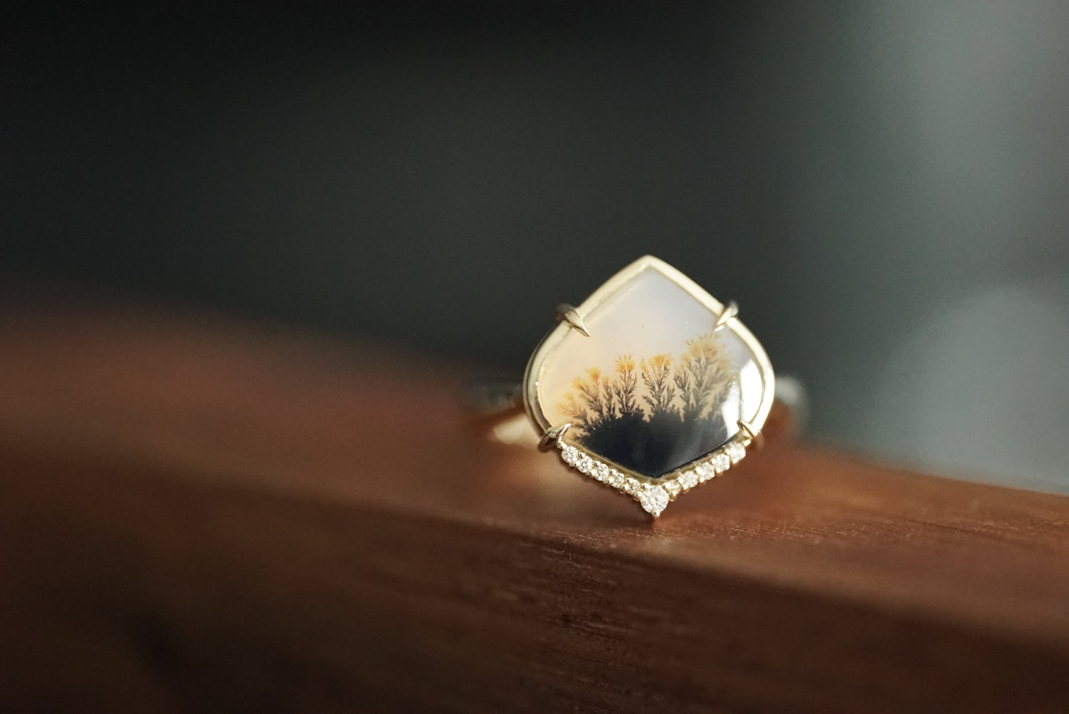 Gold ring with a unique design on a wooden surface
