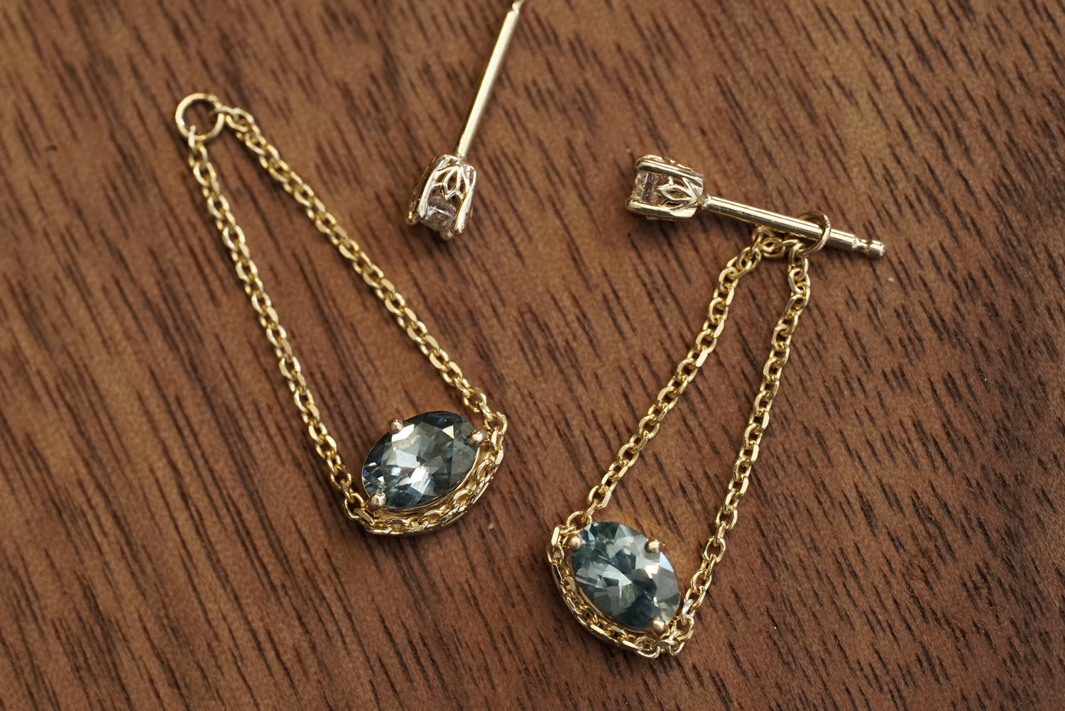 Gold necklace with blue gemstones on a wooden surface