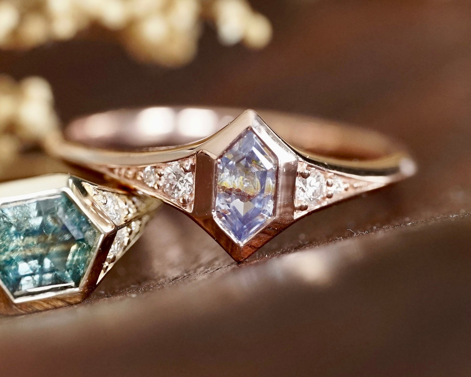 Close-up of a rose gold ring with gemstones on a blurred background