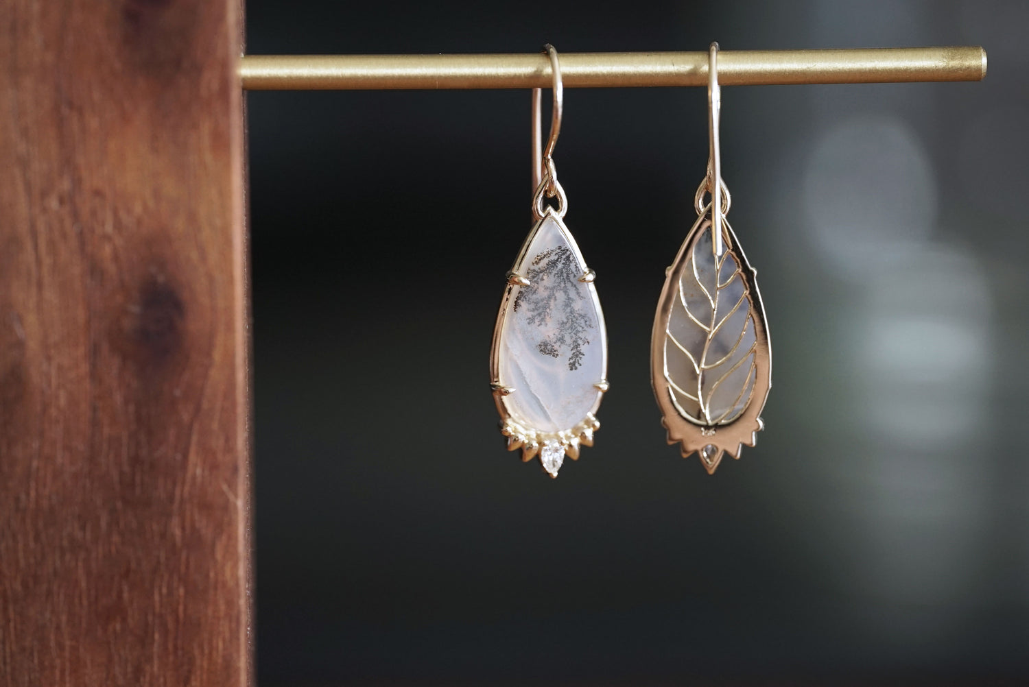 Teardrop-shaped earrings on a dark background