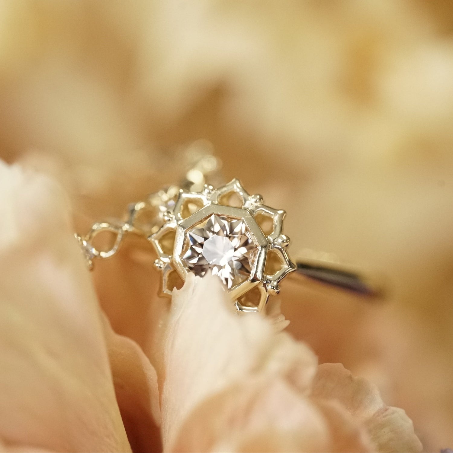Gold ring with a Octagon Tourmaline on a blurred floral background