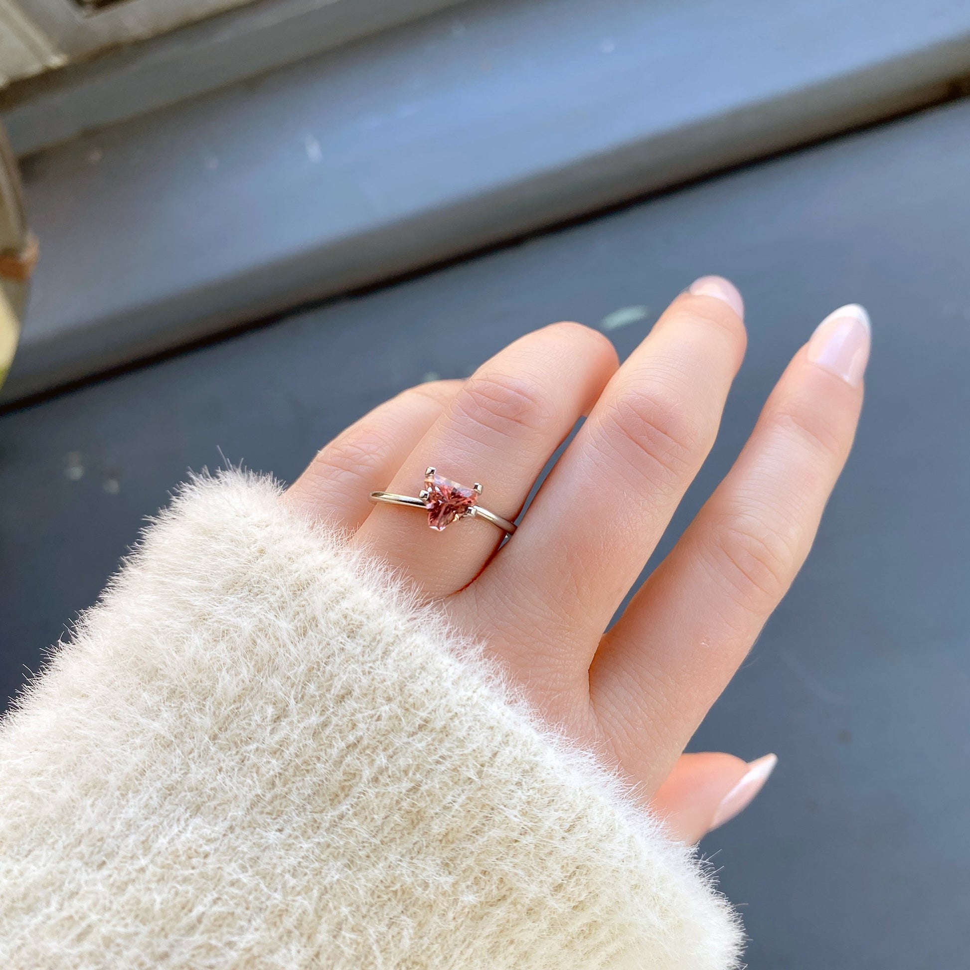 a 0.85 ct pink tourmaline in a temporary ring mount in diffused winter sunlight