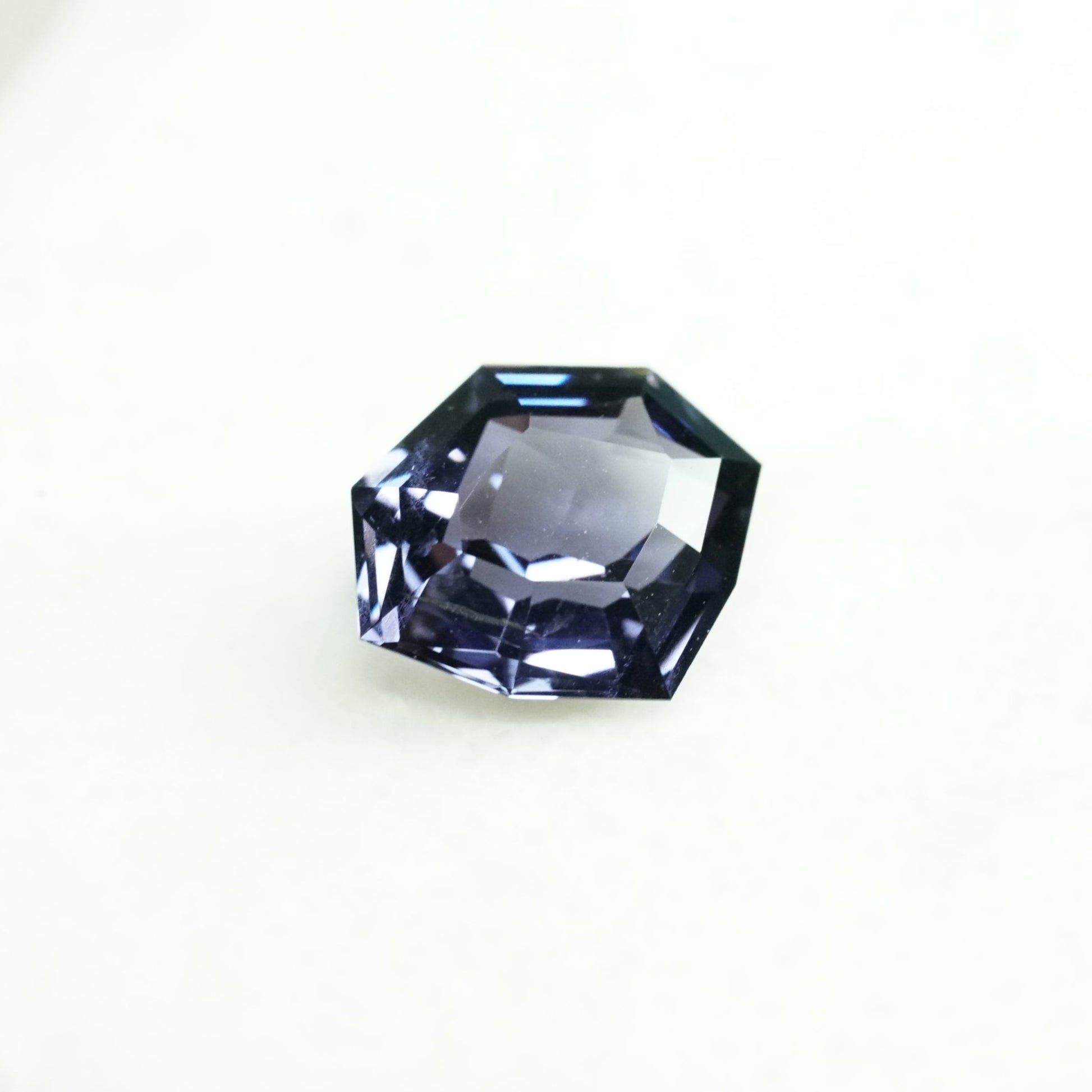 A dark violet spinel in a semi shield shape weighing 1.14 ct