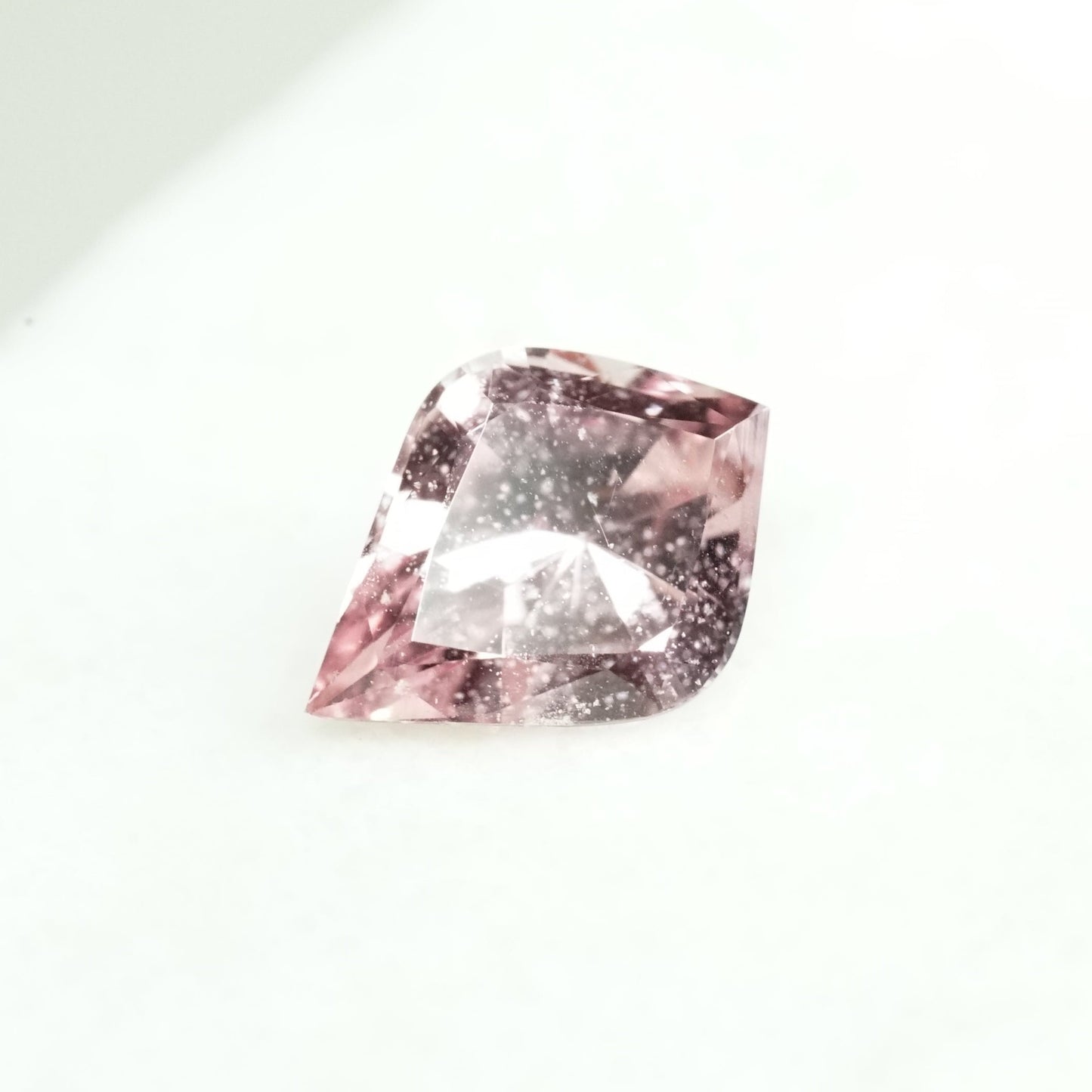 a 1.31 ct slightly organey pink sapphire in a rounded kite shape