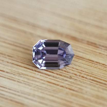 a 1.38 ct violet spinel rests on a wood base