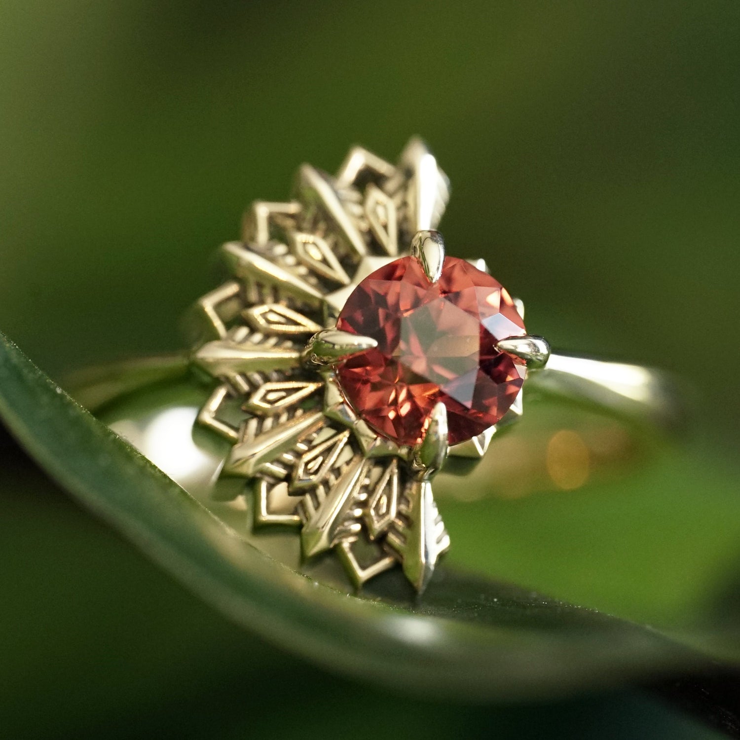 Gold Deco ring with a Lindi Garnet on a green leaf