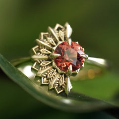 Gold Deco ring with a Lindi Garnet on a green leaf