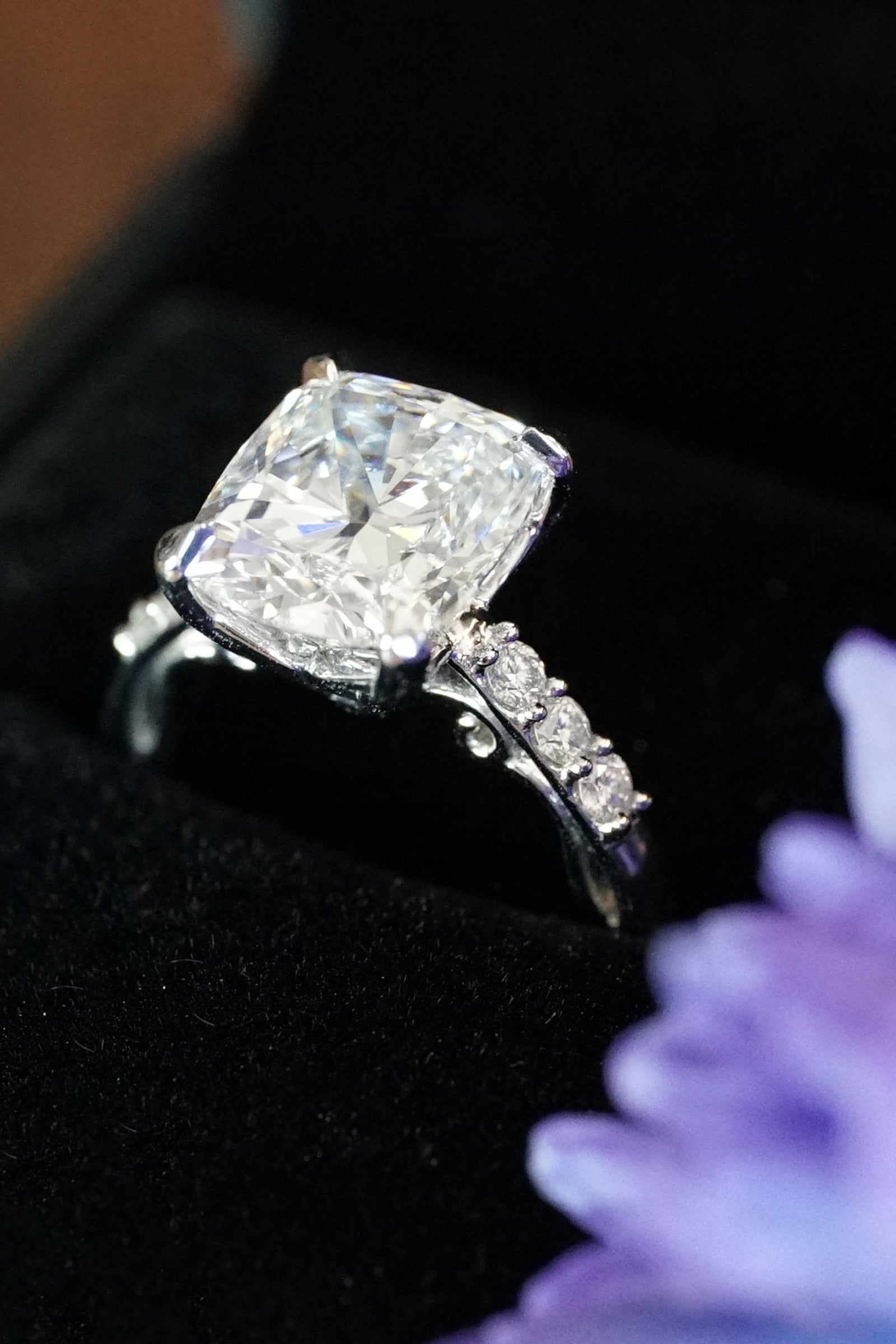 a platinum and diamond ring in a black box