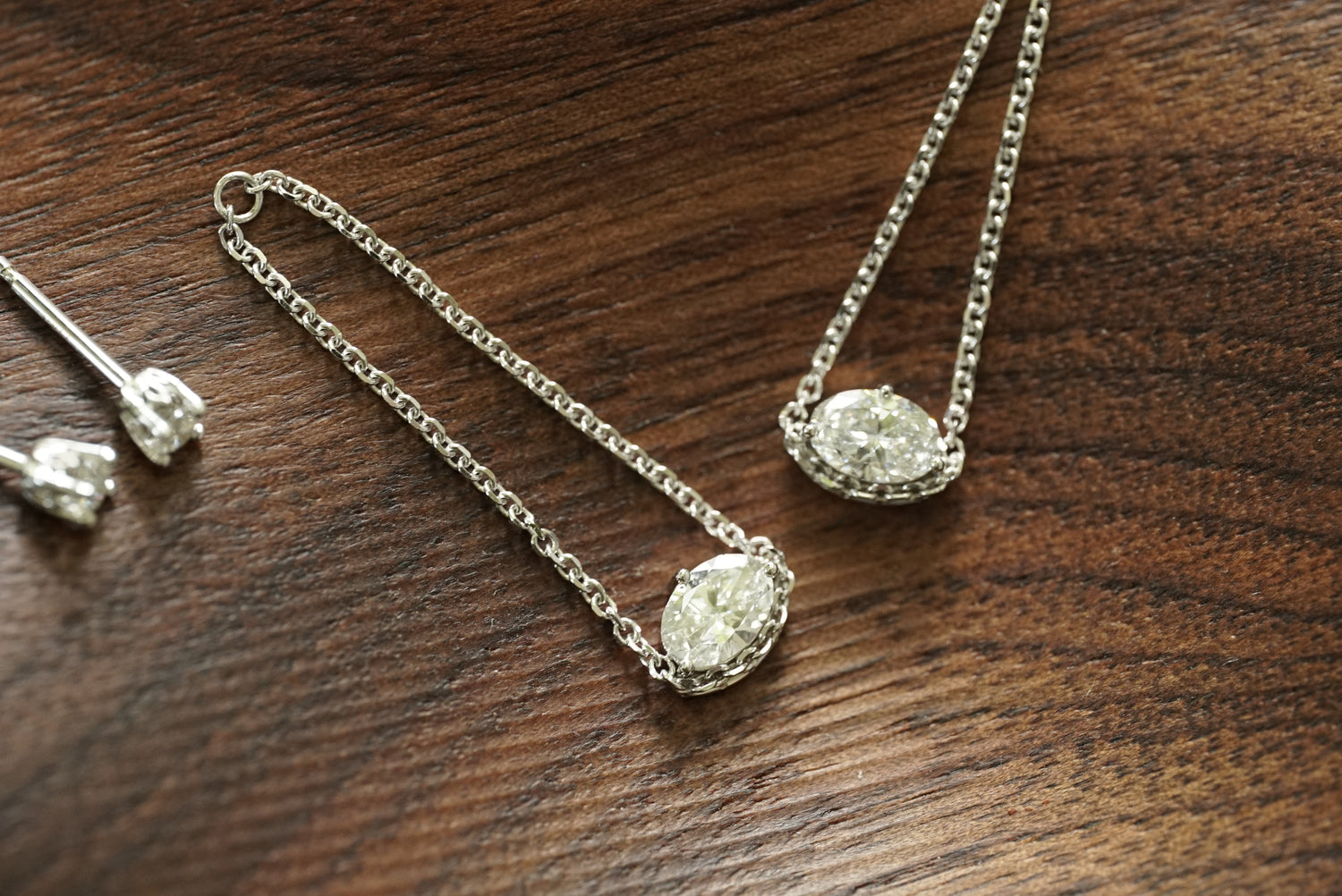 lab Diamond earrings on a wooden surface