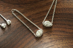 lab Diamond earrings on a wooden surface