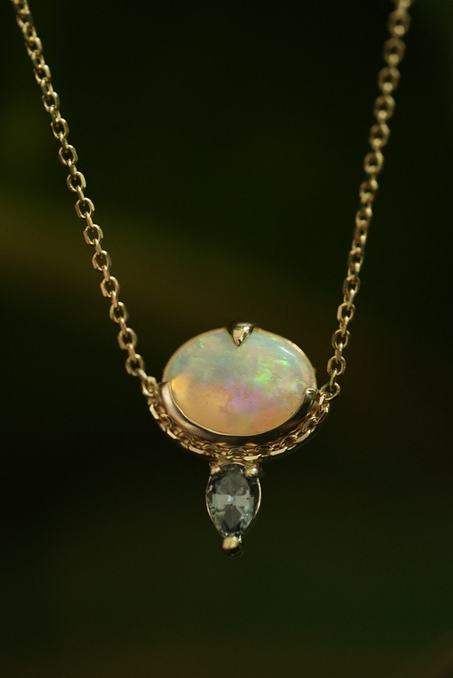 Opal pendant necklace on a dark background