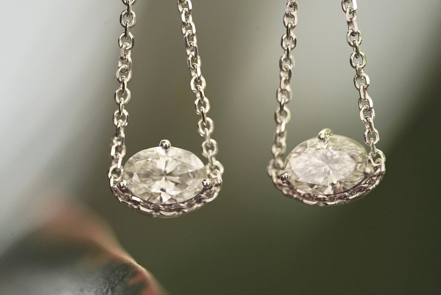Pair of diamond earrings on a blurred background