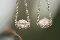 Pair of diamond earrings on a blurred background