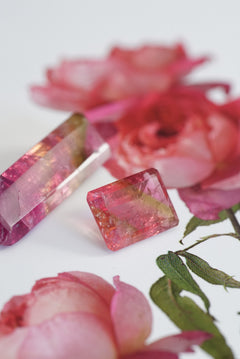 Pink tourmalines on a background with pink flowers