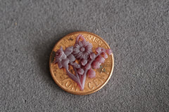 a 3d printed wax model of a custom mothers pendant shown on a penny for scale