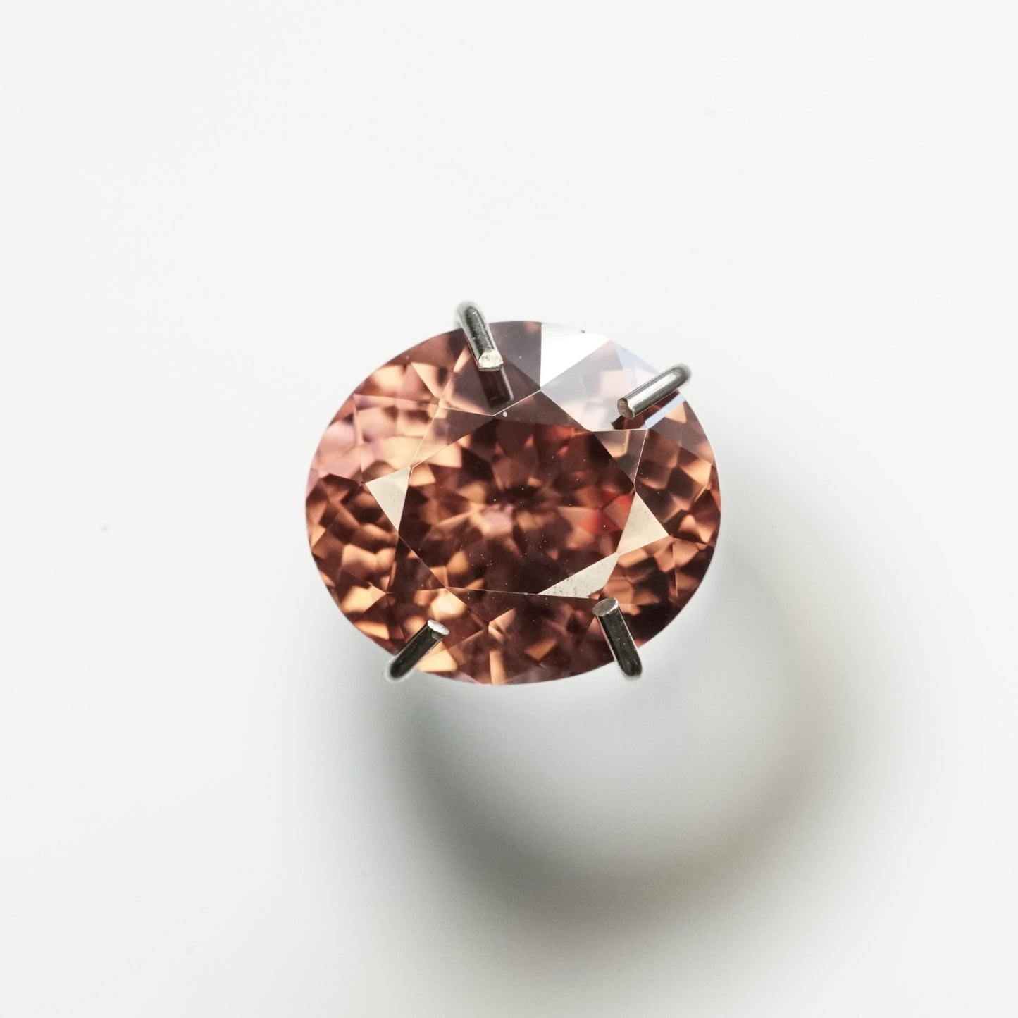 A macro photo of an oval chocolate zircon ready to be set in it's new design