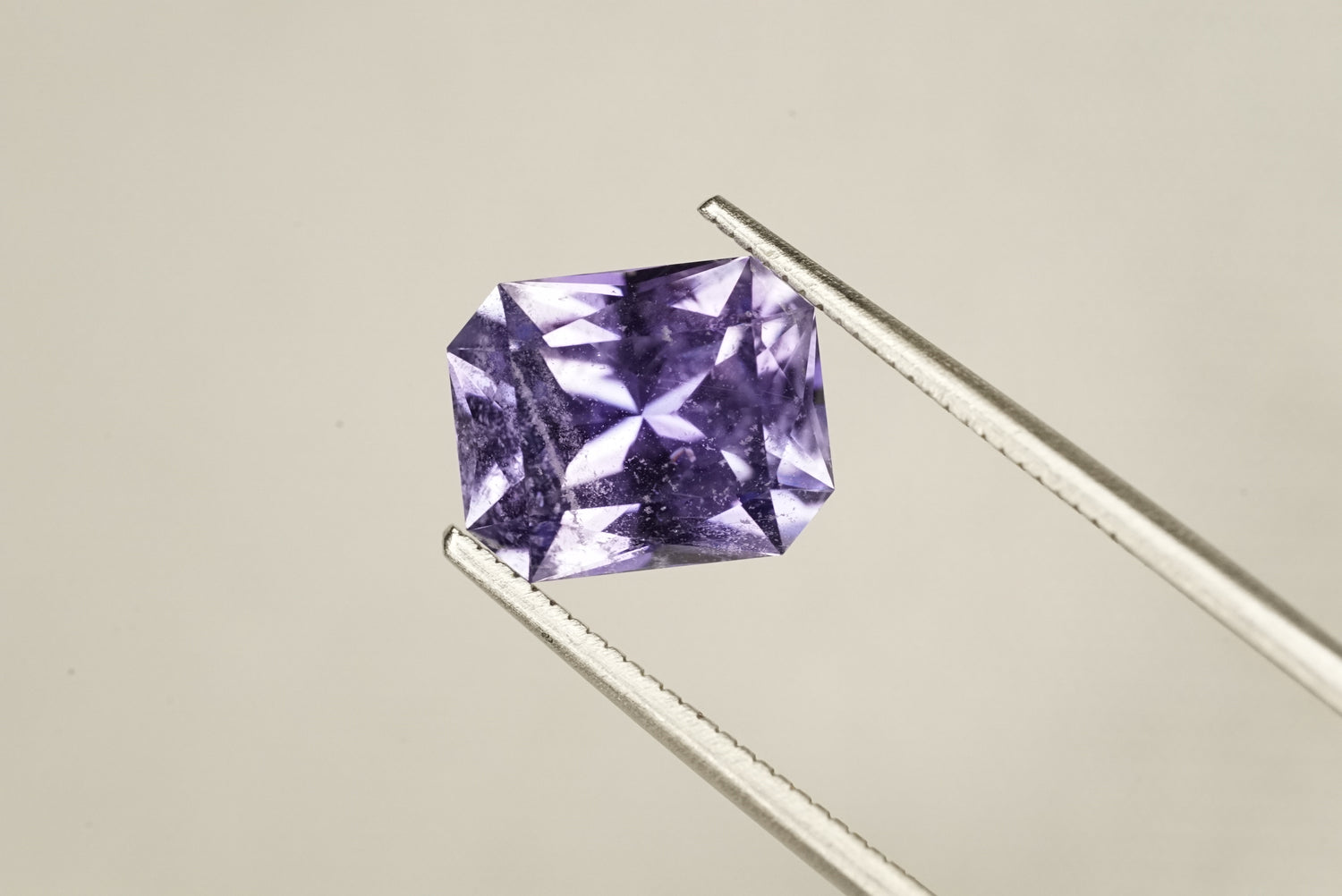 Purple gemstone on a beige background