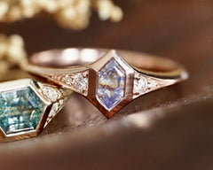 Close-up of a rose gold ring with gemstones on a blurred background