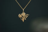 Gold necklace with a floral pendant on a dark background