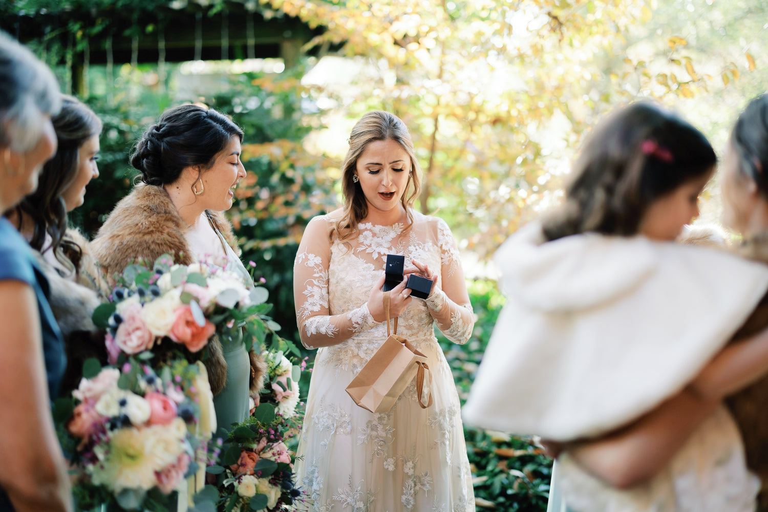 a bride is surprised by a gift on her wedding day, photograph taken by Ben and Colleen, Wedding Photographers