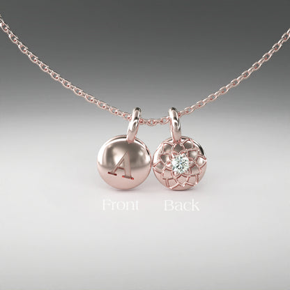 A computer rendering of a pair of rose gold and diamond pendants on a chain