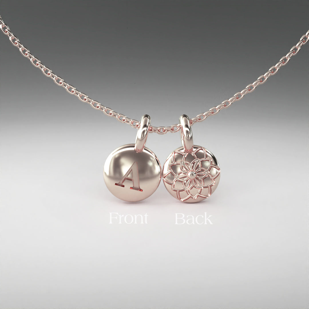 A computer rendering of a pair of rose gold pendants on a chain