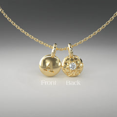 A computer rendering of a pair of yellow gold and diamond pendants on a chain