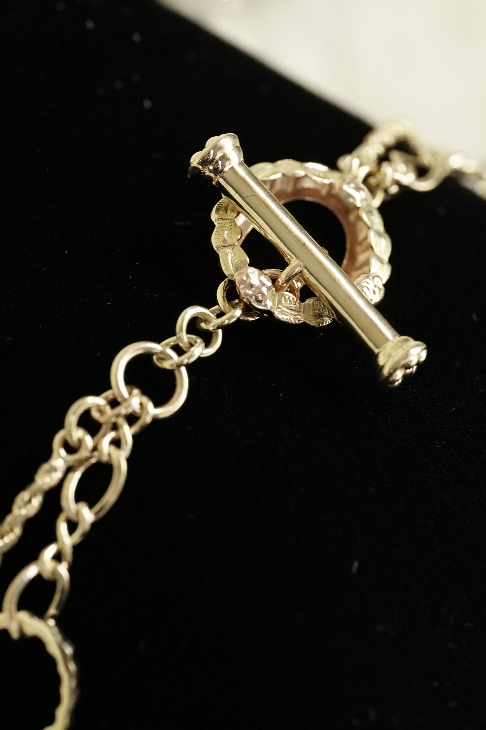 a 14k yellow gold bracelet on a black pillow