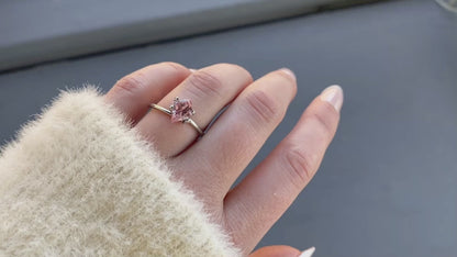 a 1.31 ct unheated orangey pink semi kite shape sapphire in a temporary ring mount in diffused winter sunlight