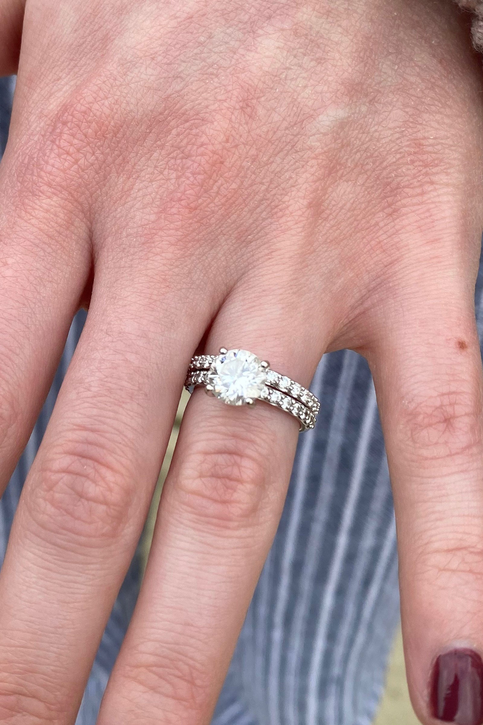 a platinum and diamond weddin set on a light skin tone hand