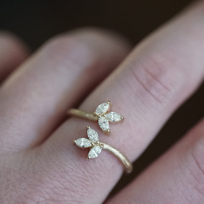 a yellow gold and diamond leaf inspired stacking ring on a light skinned left hand